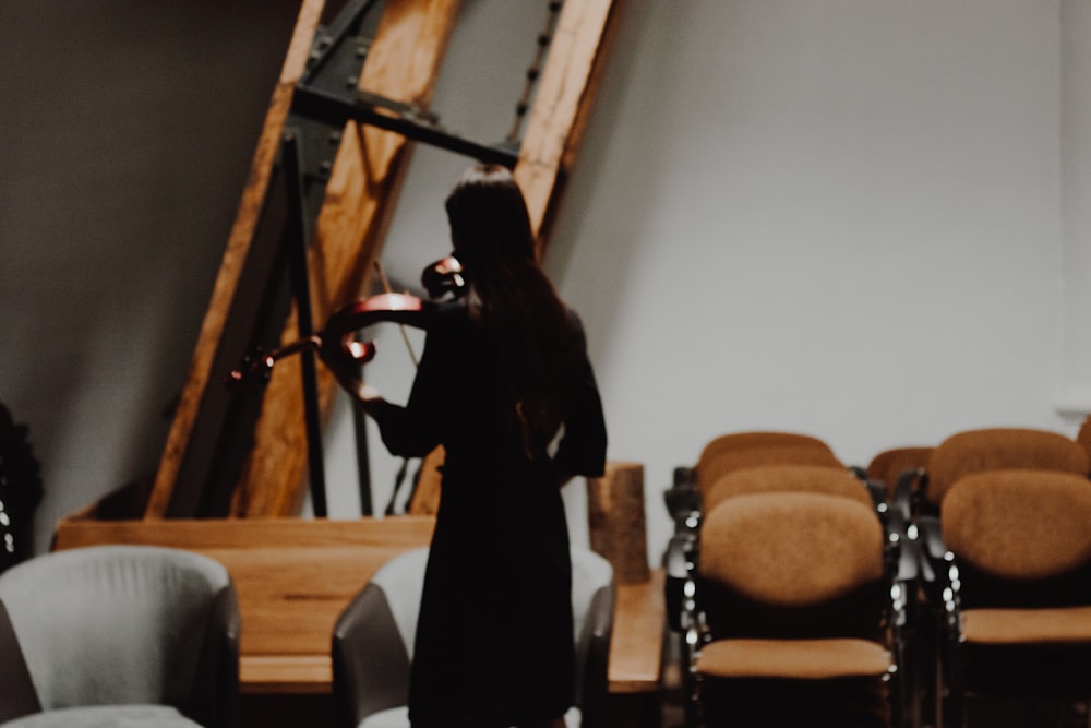 woman standing near chair