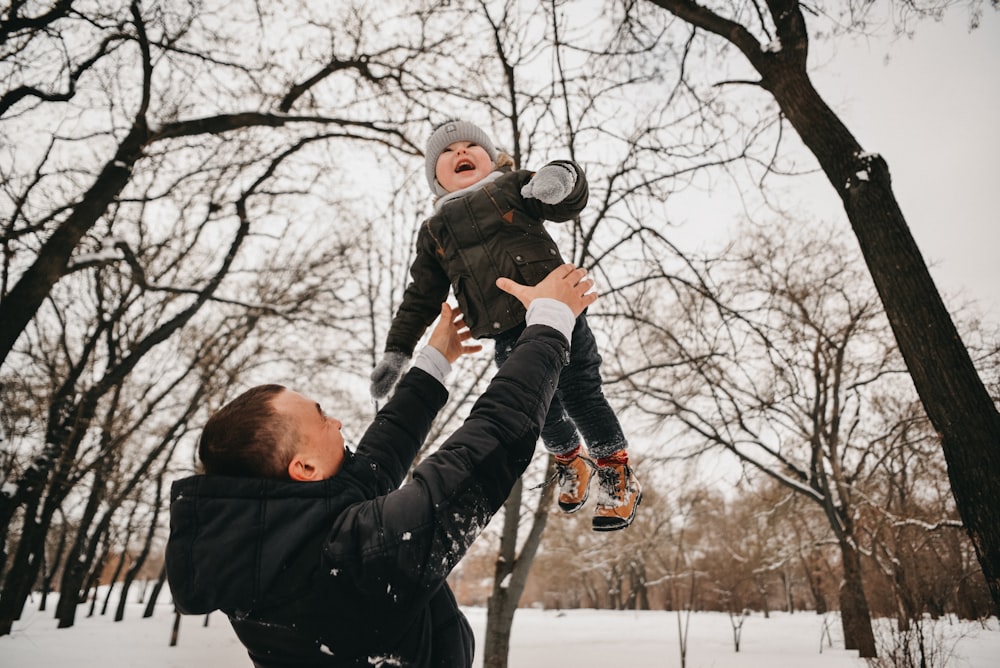 man carrying baby