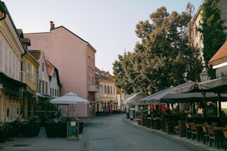 A charming street café in Martinique with colorful buildings and lush greenery.