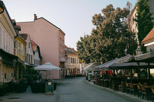 A charming street café in Martinique with colorful buildings and lush greenery.