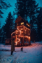woman in brown coat standing brown house