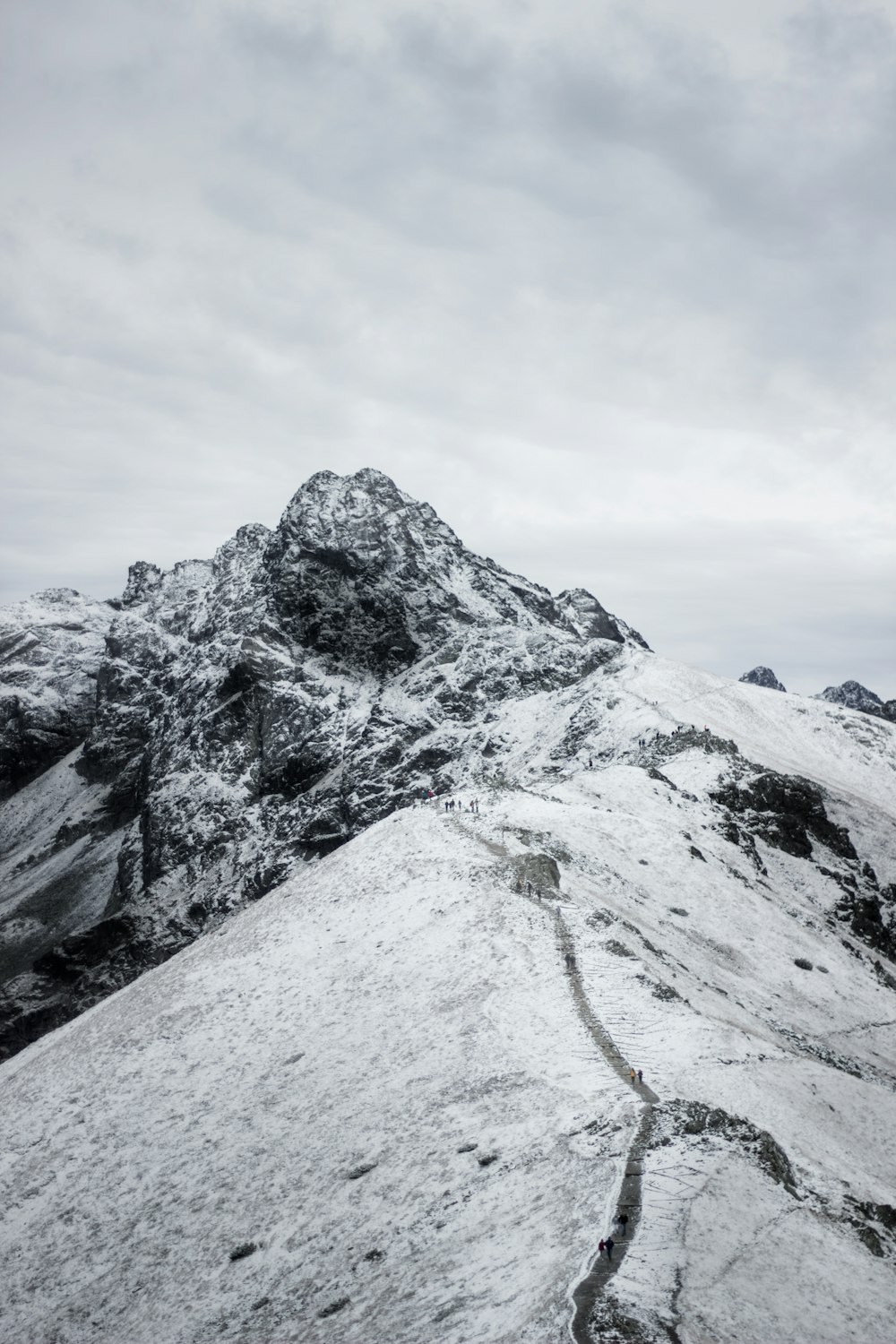 snow covered mountains under white sky during daytime