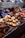 An assortment of beautifully arranged pastries and confections displayed in a bakery setting. The image features cupcakes, donuts, and various chocolates, each decorated with intricate details and toppings. The colors and textures of the sweets create a visually appealing and inviting presentation.