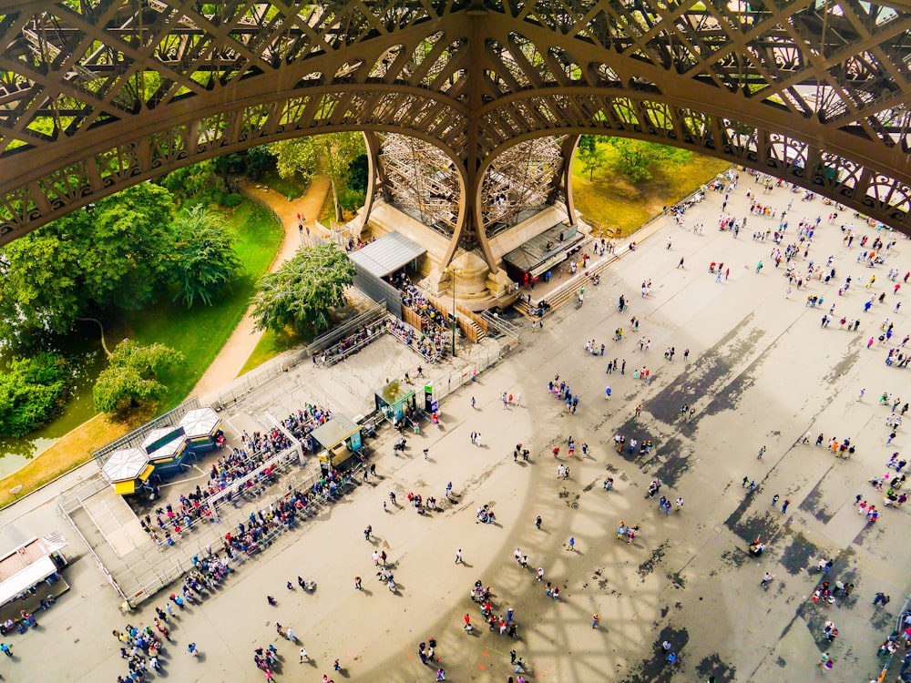 low-angle photography of people under Eiffel tower during daytime