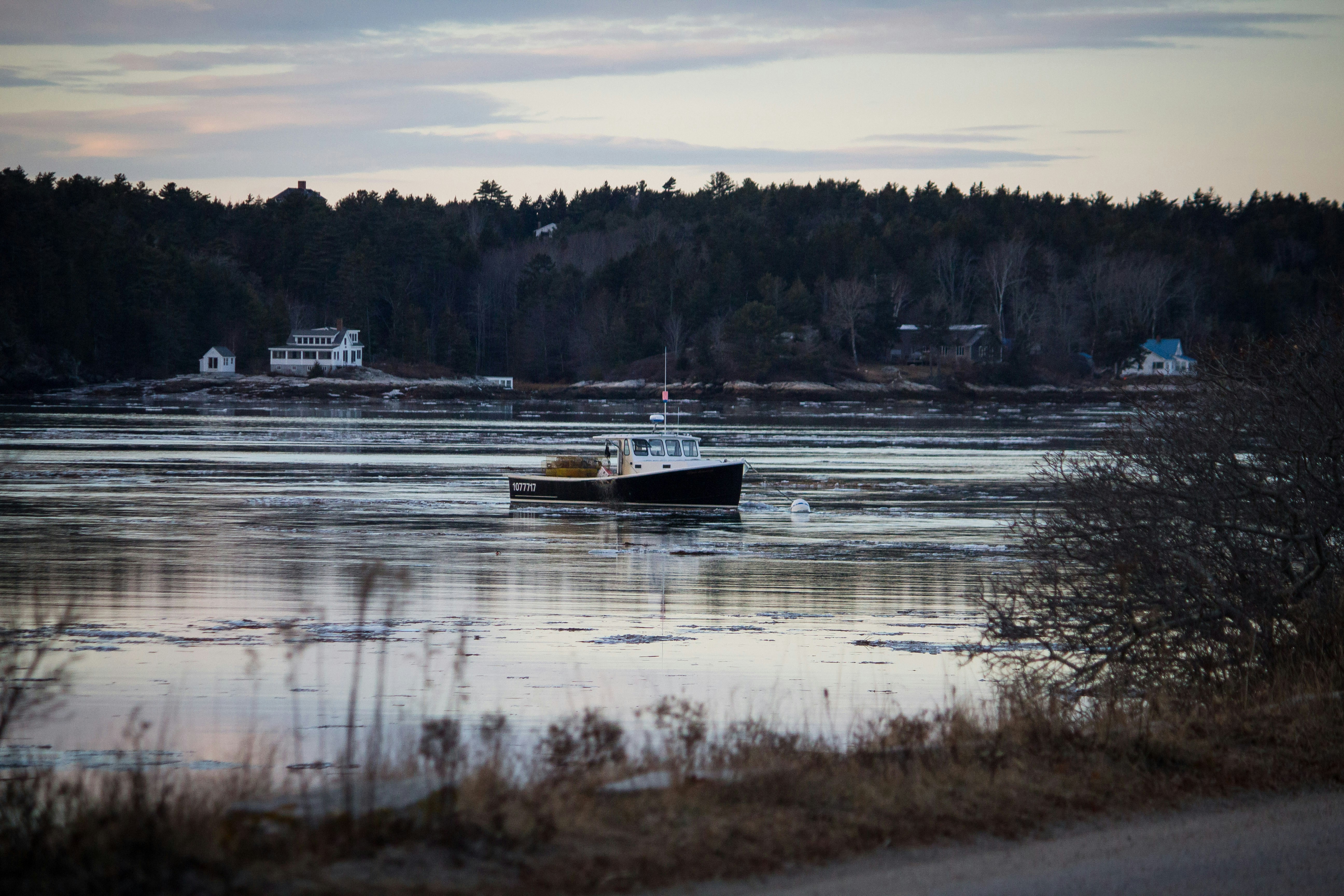 boat on body of water under gray sky