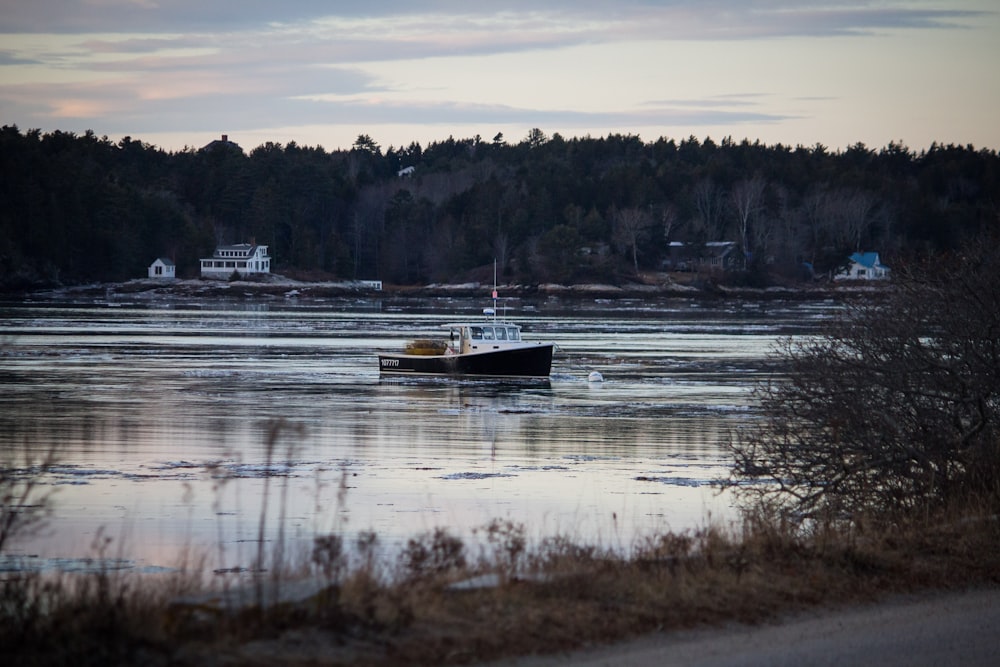 boat on body of water under gray sky