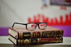 eyeglasses on stacked books