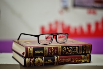 eyeglasses on stacked books