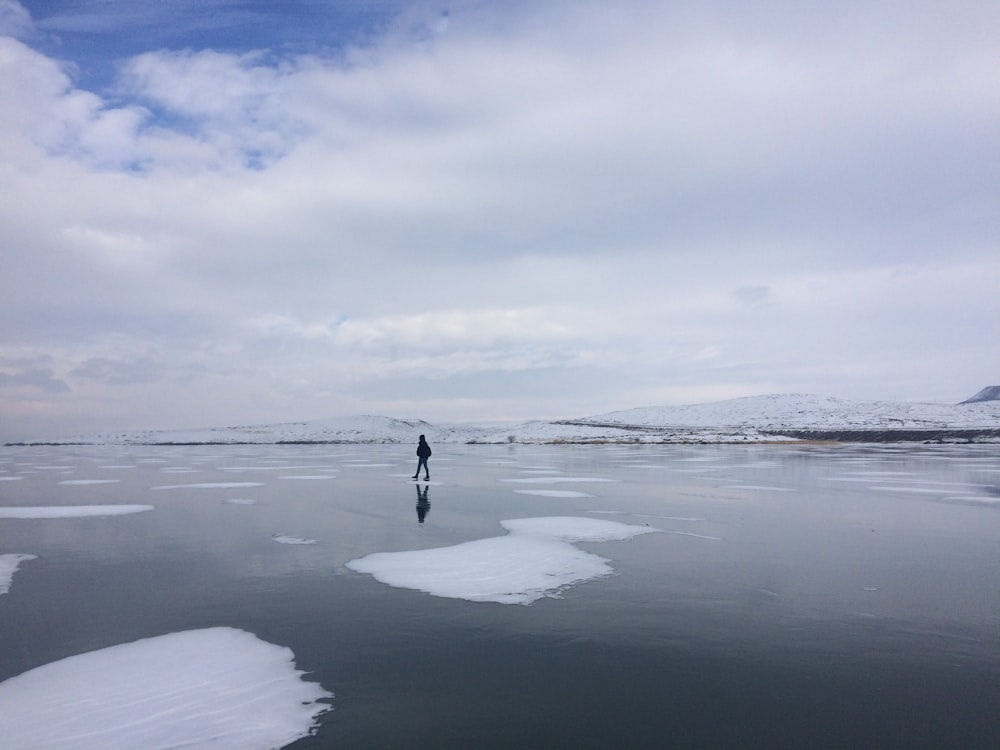 silhouette of person standing on snowfield