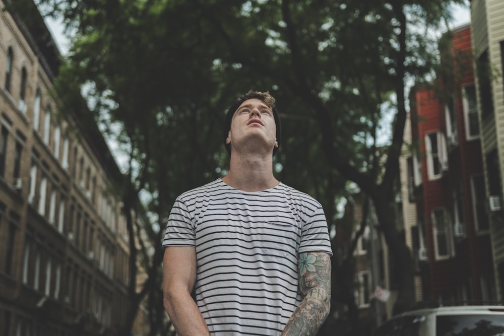 man standing under tree