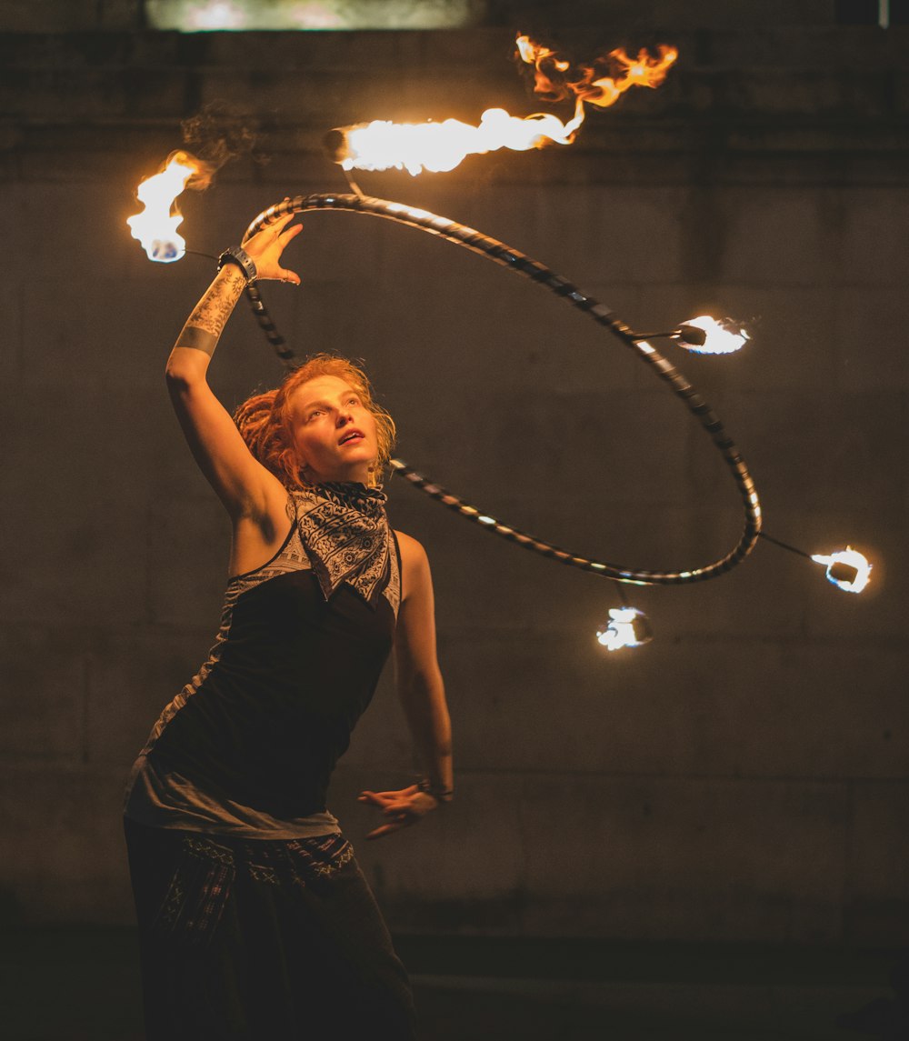 Mulher fogo dançando com aro durante a noite