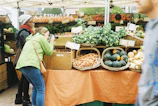 Photographer capturing a modern food market stall with fresh produce under soft natural light.
