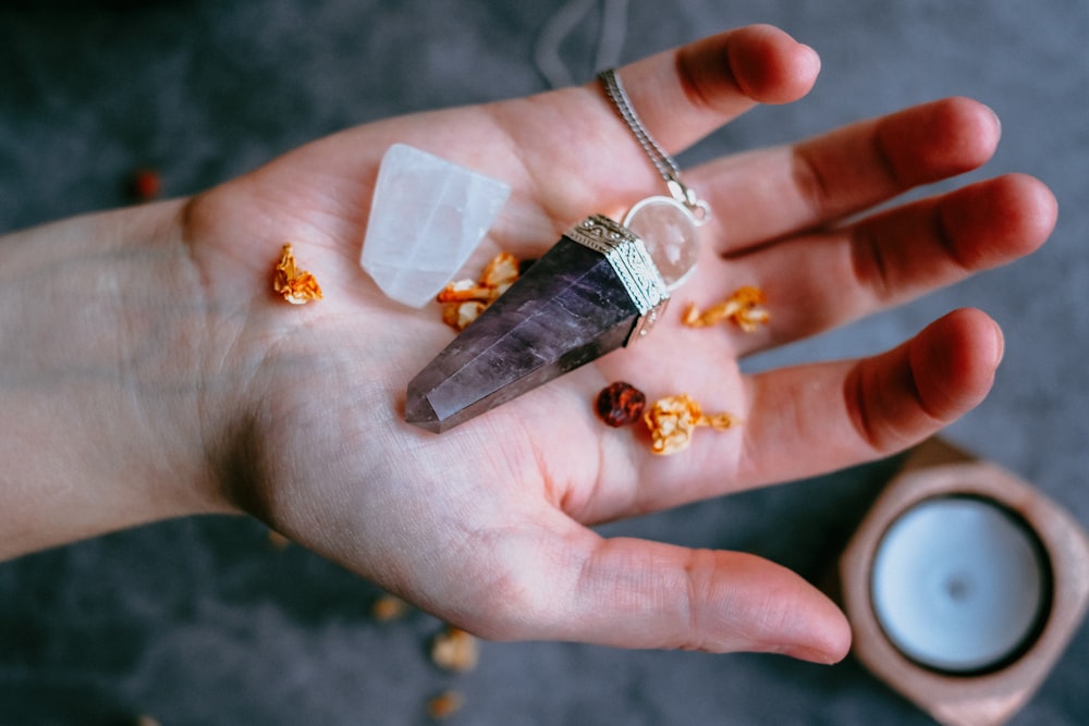 black pendant on palm