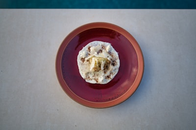 An indulgent dessert plated elegantly on a ceramic dish with a cozy kitchen backdrop