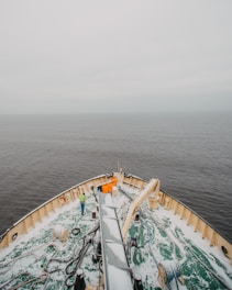 A group of diverse crew members gathered on deck, preparing for departure under clear skies.