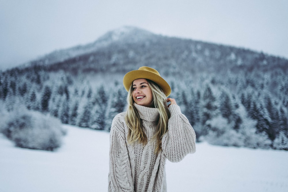 selective focus photography of smiling woman holding her hair