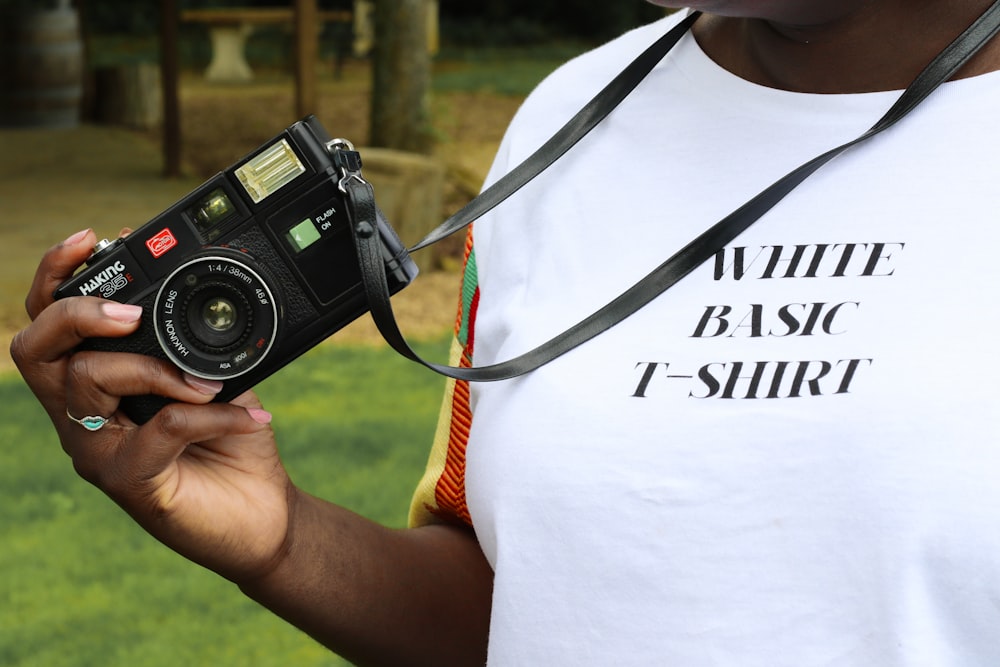 person holding black camera