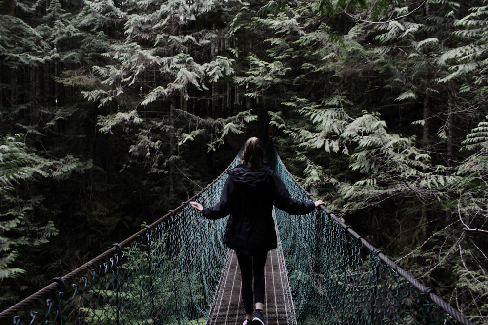 woman walking on hanging bridge