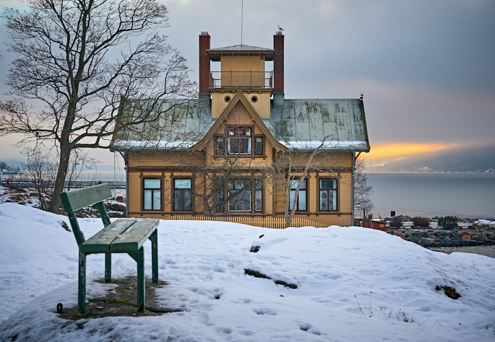 brown house covered in snow