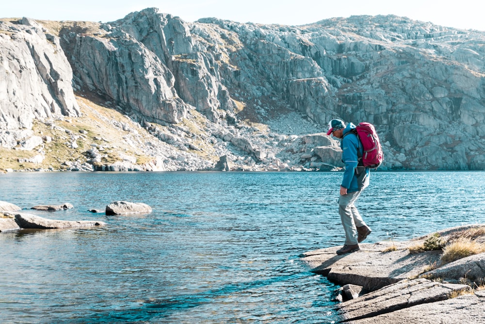 man looking at blue river