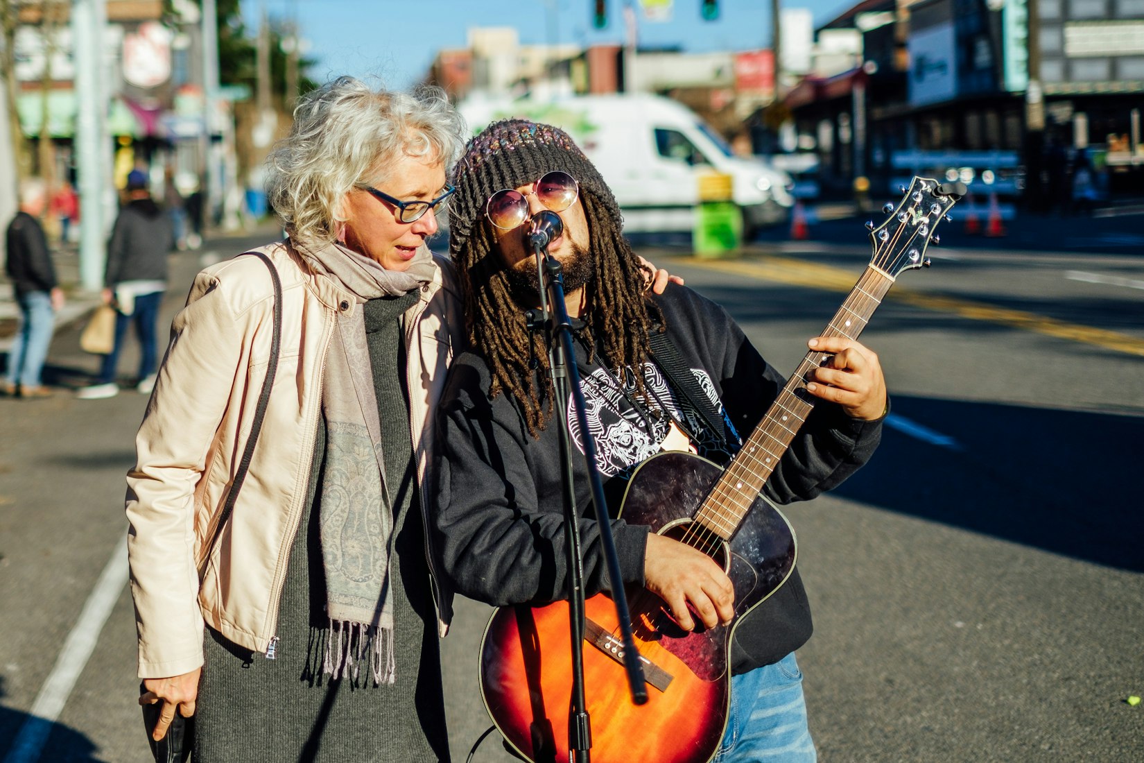 Two people singing on street