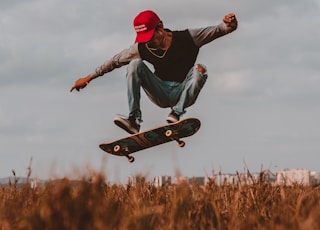 man performing skateboard trick during daytime