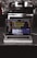 A laptop is placed on a dark granite surface. The screen displays coding software with lines of colorful code. The background features a modern kitchen with a blurred stovetop and backsplash.