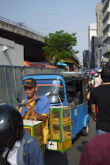 Crowded Pune street scene with bbq on wheels ambassador car and lively customers.