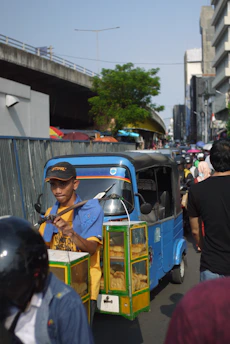 Crowded Pune street scene with bbq on wheels ambassador car and lively customers.