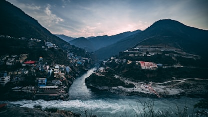 landscape photography of black and green mountains and houses