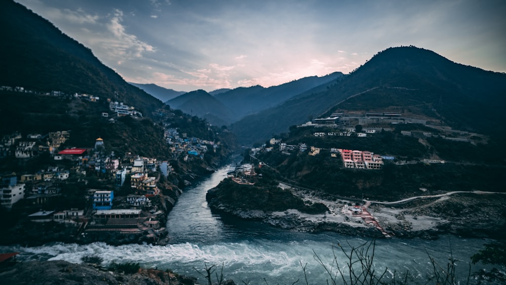 landscape photography of black and green mountains and houses