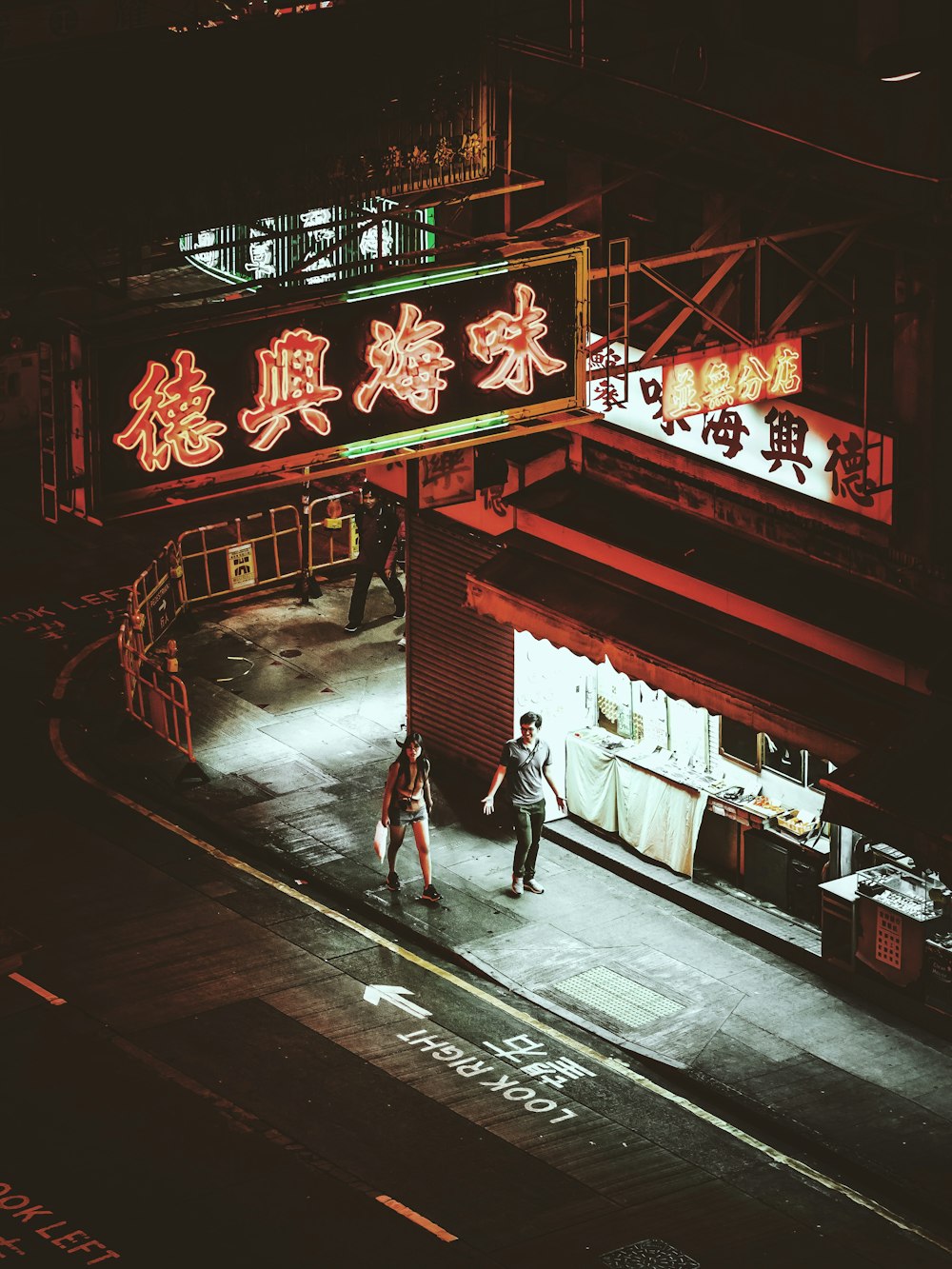 man and woman standing in front of store