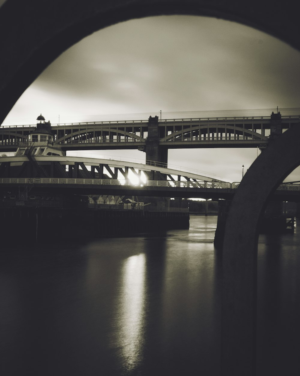 concrete bridge under gray sky