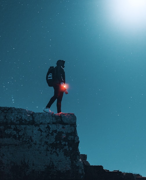 man standing on cliff