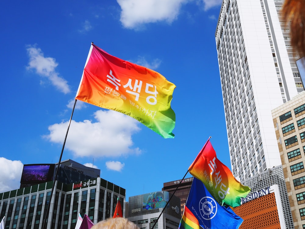 assorted-color flags by the buildings