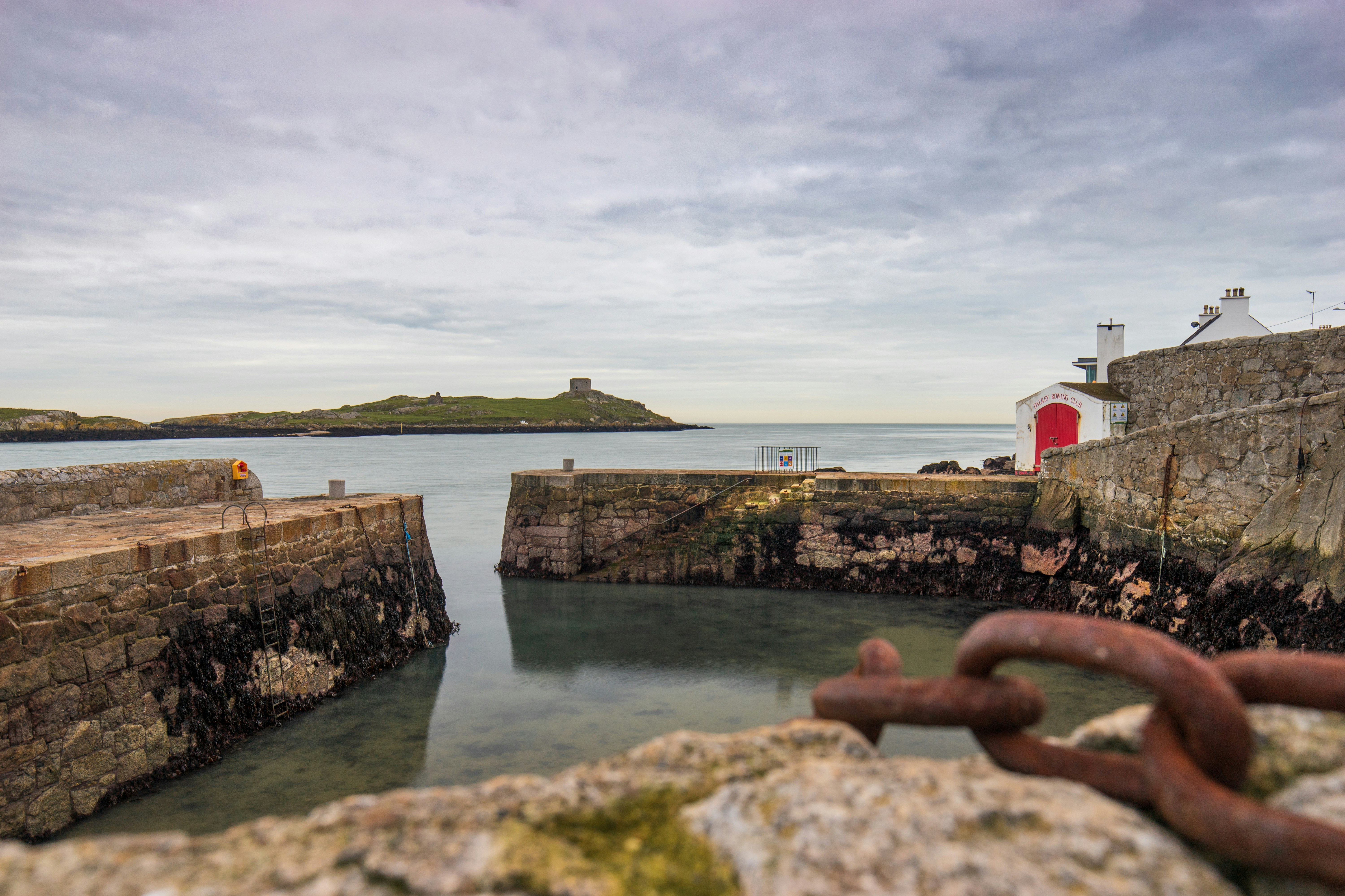 concrete buildings and walls near sea at daytime, 