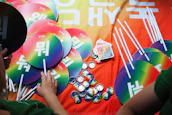 Close-up of colorful K-pop albums and merchandise arranged neatly with vibrant lighting.