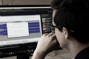 Close-up of a copywriter analyzing data on a computer screen with focused expression
