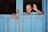 A happy senior woman waving goodbye to a driver.
