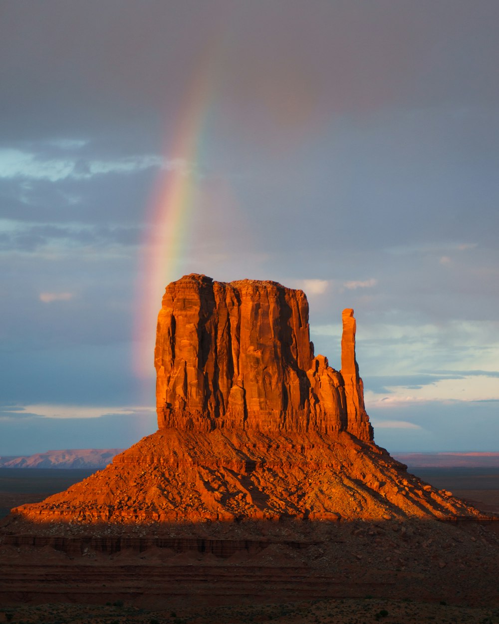 Rainbow over rock formation during daytime