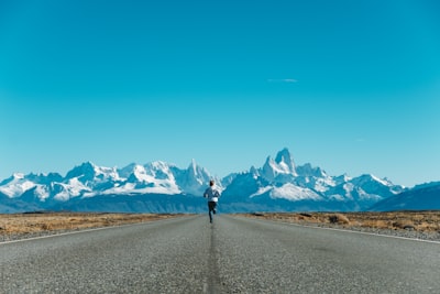 person running on road at daytime patagonia google meet background