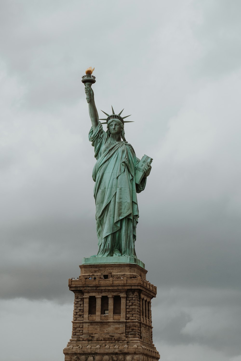 Statue of Liberty under gray sky at daytime