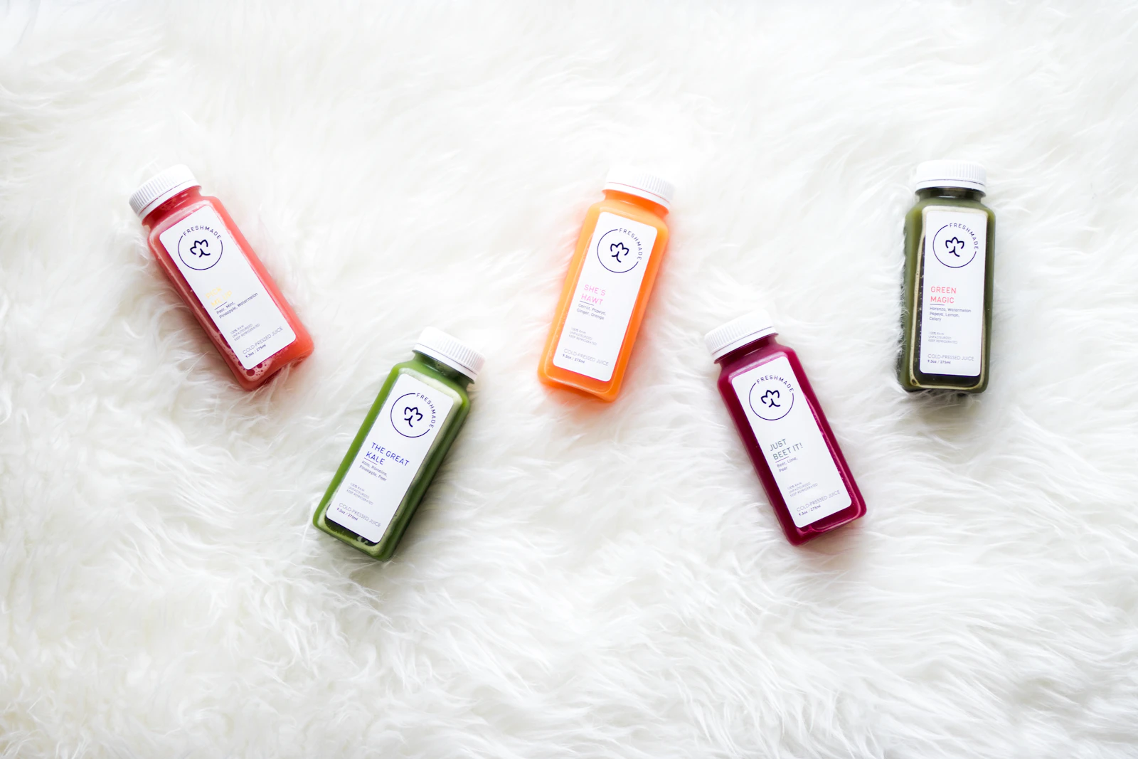 Five assorted colourful cold-pressed juice bottles