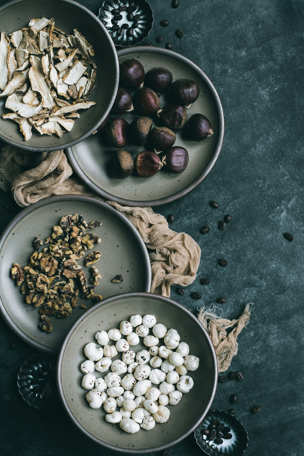 assorted herbs and nuts on grey metal bowls