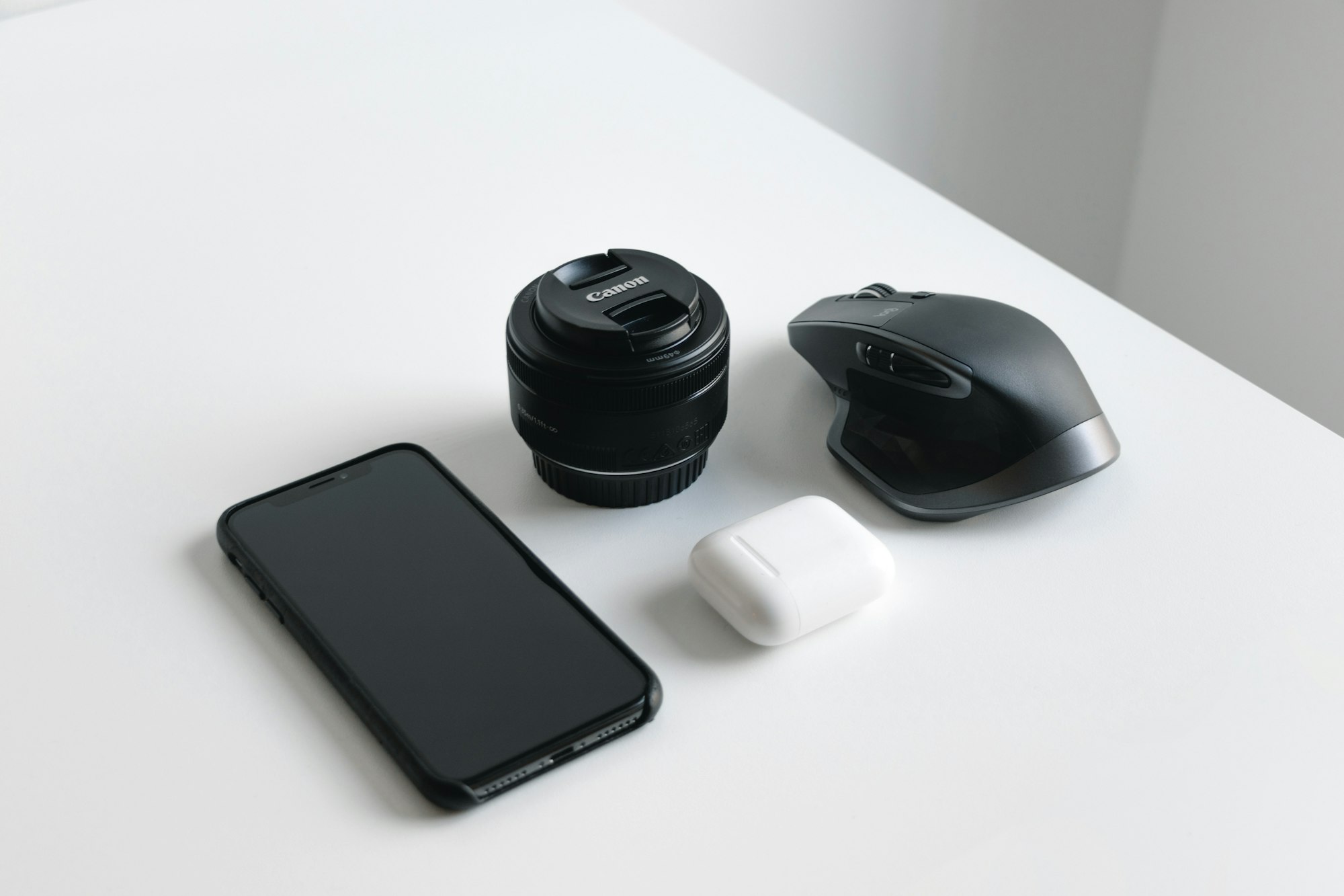 Favorite lens, phone, mouse and my trusty airpods.