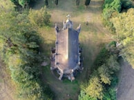 An outdoor view of a historic church surrounded by greenery.