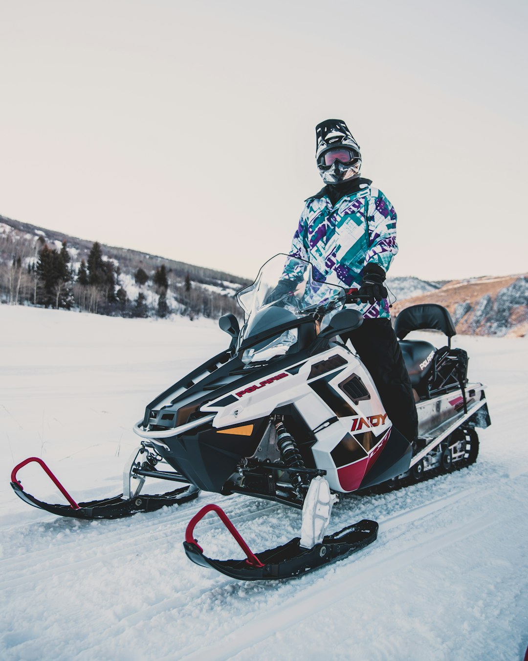 man riding white snowmobile