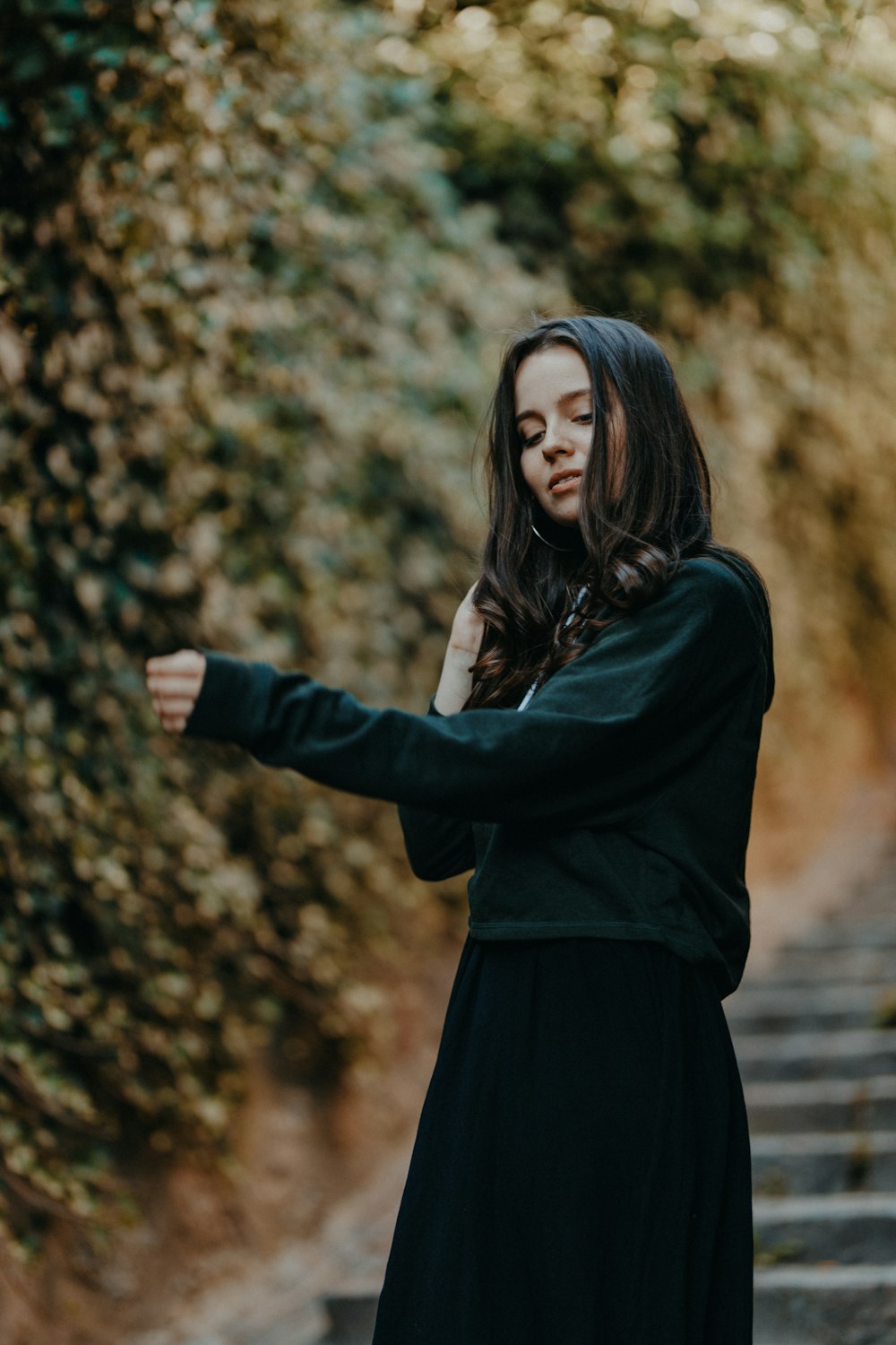 woman in black sweater near plants