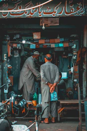 A friendly business meeting between a Mexican entrepreneur and a Chinese supplier discussing used machinery.