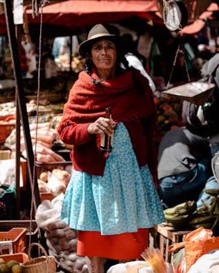 woman holding amber glass bottle